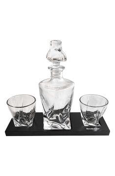 three glass bowls and a decanter on a black tray