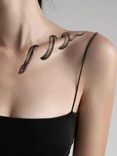 a woman with a snake tattoo on her chest