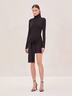 The Tracee mini dress features a high neckline and long, fitted sleeves that bring a sophisticated edge to its minimalistic silhouette. The asymmetrical draping at the hip adds a unique twist, creating a flattering and elongating effect. Turtleneck Style, Hemant And Nandita, Cami Nyc, Fitted Sleeves, Skirt Jumpsuit, Love Clothing, Crop Top Sweater, Jumpsuit Shorts Rompers, Short Rompers