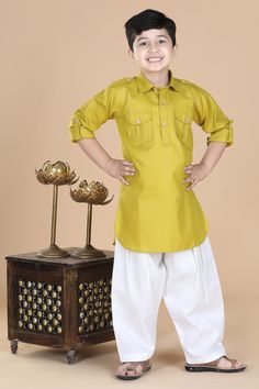 Superior in finishing. This boys pathani suit comprises kurta & salwar.The boys ethnic wear features an banded collar and beautiful button design, pocket on chest and roll up sleeve. Made from cotton fabric. This kids cloths have soft texture and the fit is regular for boys. Gold Cotton Sets For Puja, Gold Straight Kurta Set For Puja, Yellow Dabka Sets For Diwali, Yellow Long Sleeve Pant Set For Festive Season, Gold Cotton Kurta For Diwali, Gold Cotton Sets For Eid, Cotton Pant Set For Festivals, Gold Cotton Sets For Navratri, Yellow Sets For Puja And Diwali