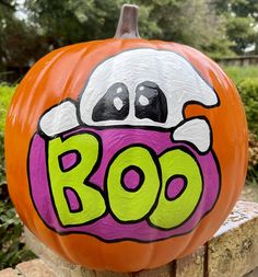 a painted pumpkin with the word boo on it