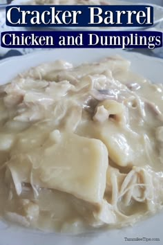 a white plate topped with chicken and dumplings covered in gravy on top of a table