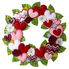 a wreath made out of felt with hearts and flowers