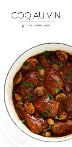 a pot filled with meat and mushrooms covered in gravy on top of a white table