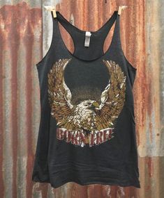 Country Deep Born Free racerback tank top Feel the vintage 70's vibes in our vintage-inspired Born Free tri-blend, black women's racerback tank top. 4.3 oz. 50% Poly 25% Cotton 25% Rayon; fits 1/3 size bigger than normal size for a looser fit Biker Chick Outfit, Plus Size Crop Tops, Rock And Roll Fashion, Born Free, Plus Size Tank Tops, Top Seller, Tankini Top, Racer Back, Racerback Tank Top