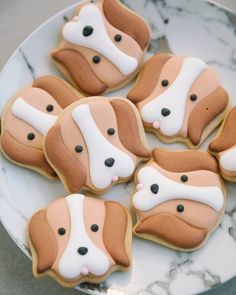 cookies decorated with dog faces on a plate