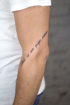 a man with a tattoo on his arm that says, there are quite enough time