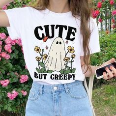 Cute but Creepy Ghost Tshirt, Retro Halloween Tee, Boo Halloween Spooky Shirts, Creepy Halloween Tee, Funny Halloween Gift Tee, UNISEX Who can resist this aesthetic retro ghost Halloween T-shirt? The quote on the tee reads 'Cute but creepy'.  It's comfy and soft and would make a perfect gift for a loved one, or for anyone who loves a funny tee or Halloween. The UNISEX shirt and available in multiple colours and sizes.  *MADE TO ORDER ITEM* - -FEATURES - - - Available in multiple colours and size Trendy Halloween Crew Neck T-shirt, Casual Halloween Graphic Print Top, Halloween Trendy Crew Neck Top, Casual Halloween T-shirt With Letter Print, Trendy Halloween Crew Neck Top, Casual Halloween Letter Print T-shirt, Casual Halloween Letter Print Top, Casual Halloween Tops With Letter Print, Cute Halloween Tops With Funny Print