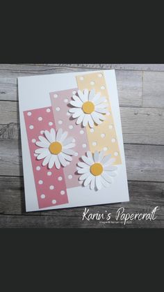 a card with some paper flowers on it