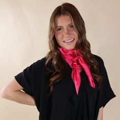 Brunette model is wearing a black drop shoulder top with a pink scarf wrapped and tied around her neck. She is pictured in front of a beige background. Classic Spring Scarves For Formal Occasions, Chic Solid Color Formal Scarves, Classic Formal Scarves For Spring, Classic Spring Formal Scarves, Chic Pink Silk Scarf For Formal Occasions, Chic Solid Scarves For Spring, Trendy Spring Scarves For Party, Elegant Summer Scarves For Workwear, Elegant Summer Scarves For Work