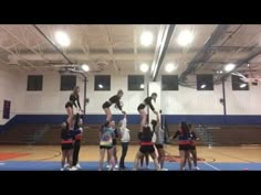 a group of people standing on top of a basketball court