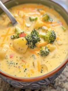 a bowl filled with broccoli and cheese soup