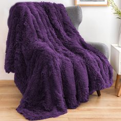 a purple blanket sitting on top of a chair