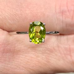 Genuine 1 Carat Peridot Oval Solitaire ~August Birthstone Ring ~ Dainty Engagement / Minimalist Fashion New! Retail Price: $119 Metal: Solid 925 Sterling Silver Finish: High Polish Hallmark: Stamped 925 Stone: Natural Peridot Stone Size: 8x6mm Stone Weight: 1.16 Carats Stone Shape: Oval Multiple Sizes Available August Birthstone Gift Box & Jewelry Cleaning Cloth Included! Perfect Genuine Gemstone Solitaire Ring! Dainty Ring Is A Perfect Everyday Fashion Or Trendy Engagement Ring! The Oval Shaped Oval Peridot Gemstones For Anniversary, Classic Peridot Jewelry With Prong Setting, Classic Peridot Birthstone Ring, Oval May Birthstone Gemstone With Center Stone, Classic Peridot Solitaire Jewelry, Classic Peridot Jewelry With Accent Stones, Classic Solitaire Peridot Jewelry, Oval Birthstone Gemstones, Classic Round Cut Peridot Jewelry