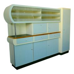 an old fashioned blue and white cabinet with wooden shelfs on the top, against a white background