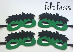 three masks with green and black hair are on a white surface next to the words felt faces