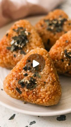 three heart shaped pastries on a white plate with black pepper sprinkles