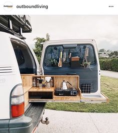 the back end of a van with an open trunk and shelves on it's side