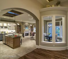 a living room filled with furniture and a kitchen