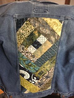 the back of a jean jacket with patchwork on it