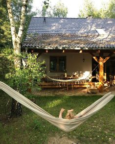 a hammock is hanging in front of a house