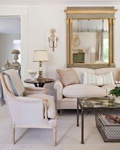 a living room filled with furniture and a mirror