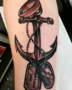 an anchor with two shoes and a hat on it