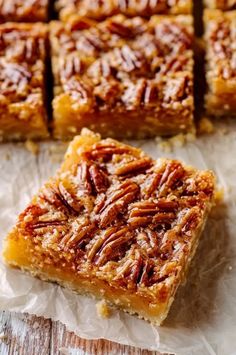 several pieces of pecan pie sitting on top of wax paper