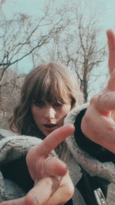 a woman making the peace sign with her fingers