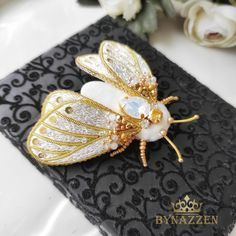 Luxury Butterfly Brooch As Gift, Luxury Butterfly Brooches For Gifts, Luxury White Brooch For Gift, Luxury White Brooches As Gift, Luxury White Brooches For Gifts, White Butterfly Brooches For Gifts, Traditional White Brooch For Gift, Luxury Handmade Brooches For Gifts, Handmade Elegant Butterfly Brooches