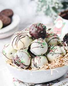 a white bowl filled with chocolate covered truffles and sprinkles