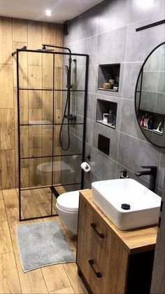 a bathroom with a toilet, sink and shower stall in the middle of the room