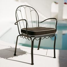 a chair sitting next to a swimming pool