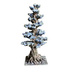 a blue and white tree sculpture sitting on top of a table