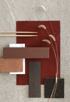 various materials are laid out on the floor with chopsticks in each one's hand