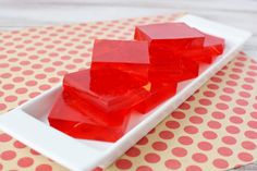 three pieces of red jelly on a white plate