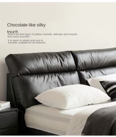 a black leather couch with white pillows on it and the words chocolate - like silky