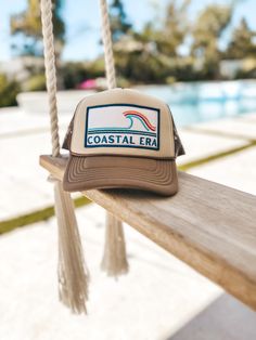 Elevate your style with the "Coastal Era Patch Hat" by Four Boys of Summer, the perfect blend of beachy vibes and timeless fashion. This unisex Beach Trucker Hat features a bold, colorful wave patch, capturing the spirit of the coast, making it an ideal Beach Lovers Gift. The earthy brown hue of the 5-panel Foam Trucker Hat adds a grounded touch, beautifully balancing the lively coastal design for a modern yet classic look. Crafted for ultimate comfort, this lightweight Surf Trucker Hat is made Hat Aesthetic, Beach Lover Gifts, Beach Wave, Beachy Vibes, Earthy Brown, Patch Hat, Retro Waves, Coastal Christmas, Coastal Design