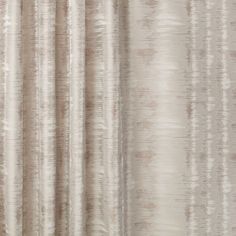 a close up view of a curtain with white and beige stripes