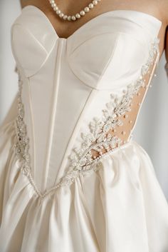 the back of a wedding dress with beading on it