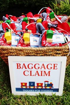 a basket that has some bags in it and is on the grass near a sign