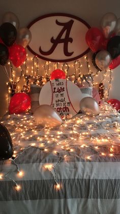 a bed topped with lots of balloons and lights