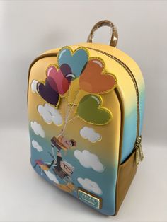 Description: Loungefly Disney Pixar Up Heart Balloons Mini Backpack New With Tags Show your love for adventure and carry around your necessities all in one stylish mini backpack from Loungefly! Featuring a graphic of Russell, Carl, Kevin, and Dug flying away on the die-cut heart balloon appliqués for a day full of fun, this Up-inspired bag is a great way to bring a touch of Disney•Pixar magic to your next Wilderness Explorer camping trip outfit. Also features an enamel brand badge, gold-toned hardware, adjustable shoulder straps, and an interior lining pattern of the movie's characters. Polyurethane; polyester lining Approx. 8 1/2" W x 11 1/2" H x 5" D Imported Condition: Factory New Fun Travel Backpack With Zipper Closure, Cute Multicolor Backpack For Disney Trips, Multicolor Backpack For Disney Fan Events, Playful Backpack For Disney Trips, Fun Multicolor Backpack For Disney Trips, Disney Multicolor Standard Backpack, Disney Style Multicolor Standard Backpack, Multicolor Disney Backpack, Themed Multicolor Travel Bag