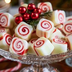 a glass bowl filled with white and red candy canes