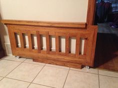 a wooden bench sitting on top of a tile floor next to a wall and door