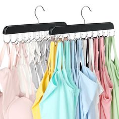 an assortment of shirts hanging on hooks