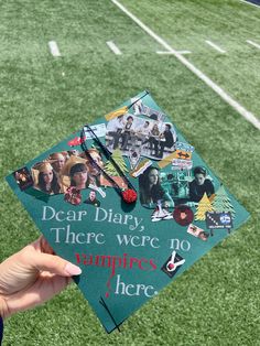 someone holding up a graduation cap with pictures on it that says dear diary, there were no vampires here