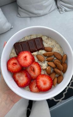 a bowl of oatmeal with strawberries and almonds