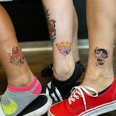 two people with matching tattoos on their legs, one is wearing red shoes and the other has