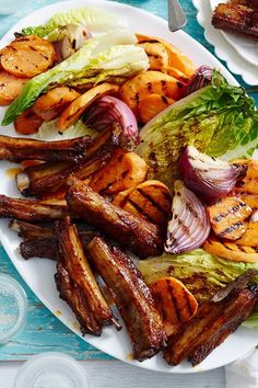 grilled meat and vegetables on a white plate